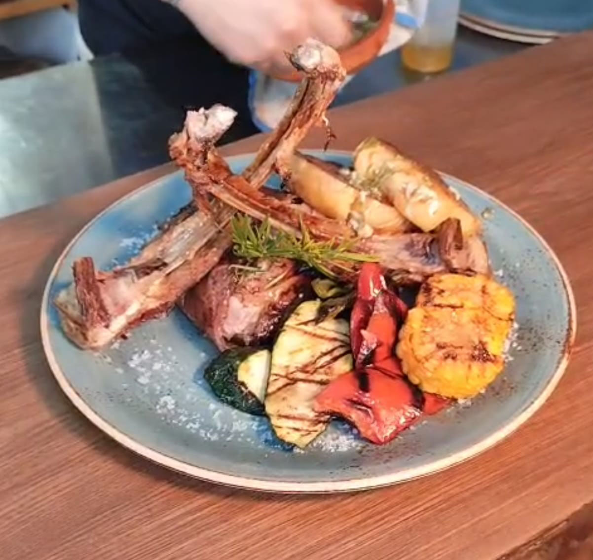 Grilled meat and vegetables plated at Can Bestia